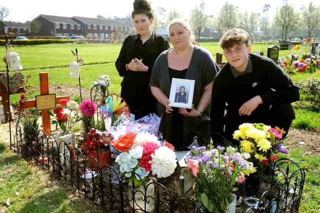 Anger over removal of fences around graves at Snell Hatch Cemetery, Crawley. Natasha Davis, with her children Liam and Sophie at Natasha's mother's grave. Pic Steve Robards SR1706046 SUS-170327-151056001